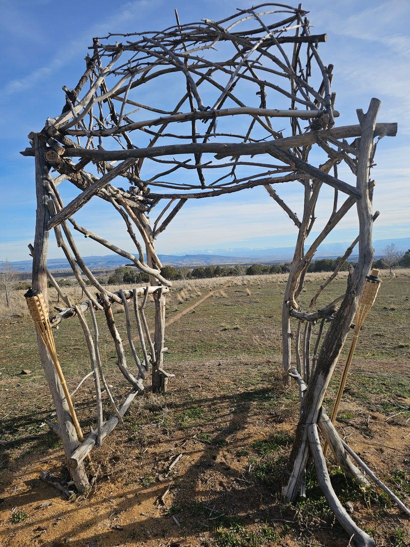 Rustic branch archway on the Bowler property in Cedaredge